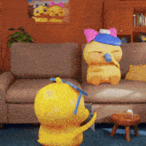 two cartoon ducks are sitting on a couch and one is wearing a pink bow