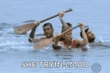 a woman in a red bikini is swimming in a pool with a group of people and yelling .