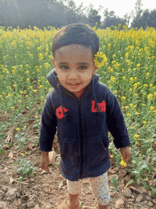a little boy wearing a blue jacket with the letter l on it