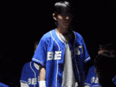 a man wearing a blue jersey that says bee on it