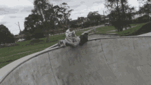 a person riding a skateboard on a ramp with a shirt that says nike