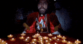 a man with a beard is standing in front of a table with candles and says i am the pope of dope