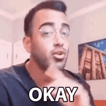 a man with glasses is making a funny face and saying `` okay '' .