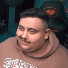 a man wearing a limited edition sweatshirt looks at the camera