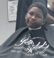 a boy getting his hair cut at gerald 's greatest stylists in the world