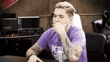 a man wearing a purple shirt that says " petra " on it