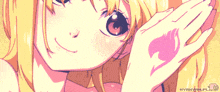 a close up of a girl 's face with a fairy tail symbol on her hand