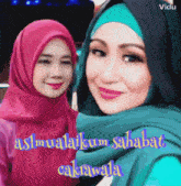 two women wearing hijabs are posing for a picture and the caption says " assalamalaikum sahabat "