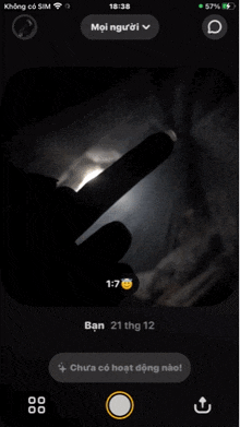 a phone screen shows the time as 18:38 and a person 's finger pointing at the moon