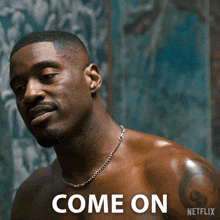 a shirtless man with a chain around his neck is next to a netflix logo