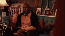 a man is sitting on a couch with the words na igreja com estilo on the bottom