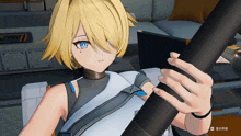 a girl with blonde hair and blue eyes holds a black object in her hand