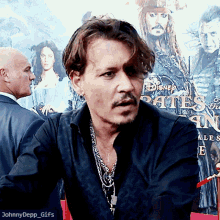 a man sitting in front of a disney poster