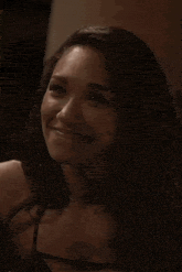 a close up of a woman 's face with a smile on her face .