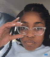 a woman wearing glasses is sitting in a car