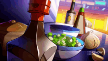 a bowl of green onions sits on a table next to bottles of sauce