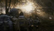 a group of people with backpacks are walking through a forest