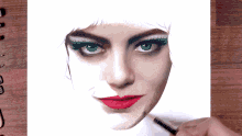 a drawing of a woman 's face with red lips and green eyelashes