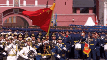 a group of soldiers marching in front of a building with the number 10 on the top