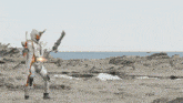 a person in a white costume is standing on a rocky beach