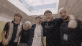 a group of young men are posing for a picture together .