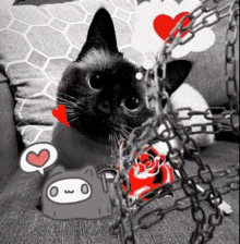 a black cat is chained to a pillow with a heart and a speech bubble that says owo