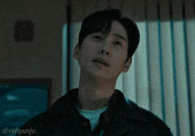 a close up of a man 's face with divahyunju written below it