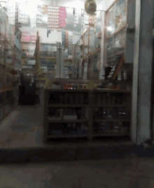 the inside of a store with lots of shelves and a fan
