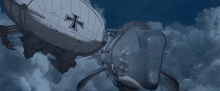 a white airship with a black cross on the side is flying next to a whale