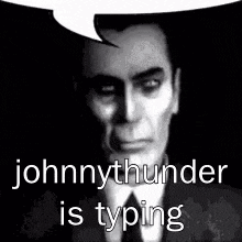 johnnythunder is typing in a black and white photo of a man in a suit and tie .