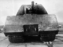 a black and white photo of a very old tank sitting on the ground .