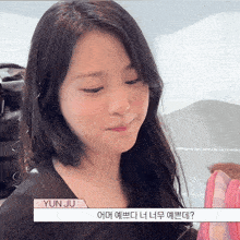 a young girl with yun ju written on her shoulder