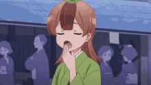 a girl in a green kimono is yawning with her eyes closed