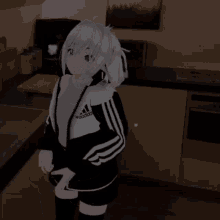 a girl wearing a black and white adidas jacket