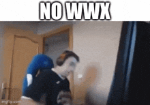 a man is sitting in front of a computer screen with the words nowwx written above him