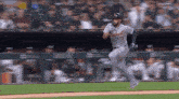 a baseball player with the number 31 on his jersey is running on the field