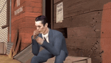 a man in a suit is sitting in front of a building with a sign that says no smoking