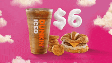 a cup of dunkin ' iced coffee next to a breakfast sandwich and nuggets
