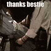 a woman is putting a shirt on a man 's chest and says thanks bestie .