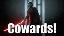 a picture of a man holding a red light saber with the words cowards behind him