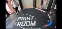 a boxing ring with the words fight room written on the mat