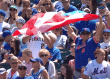 a man in a pirate jersey holds up a flag
