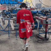 a man wearing a red t-shirt that says precision on the back