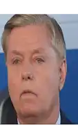 a close up of a man 's face with a serious expression
