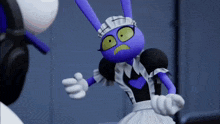 a purple bunny wearing a maid outfit is dancing in front of a white robot .