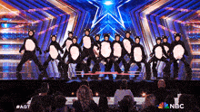 a group of people dressed in cat costumes are performing on a stage