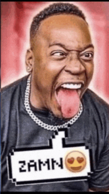 a man is sticking his tongue out and wearing a shirt that says zamn on it
