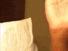 a close up of a person 's face with a roll of toilet paper in the background