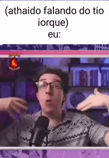 a man wearing glasses is talking into a microphone and making a funny face .