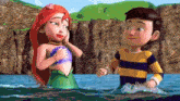 a boy and a mermaid are standing in the water and talking to each other .